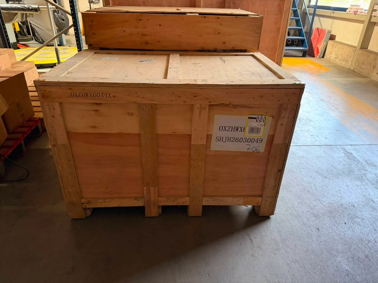 Closed wooden machinery case on a timber base at a French customer’s factory after sea freight